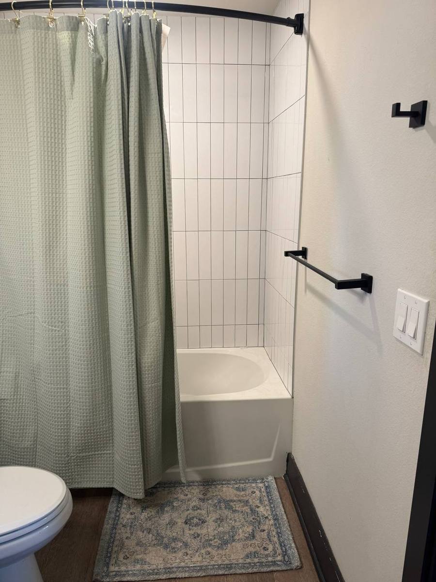 Private bathroom with tub and shower